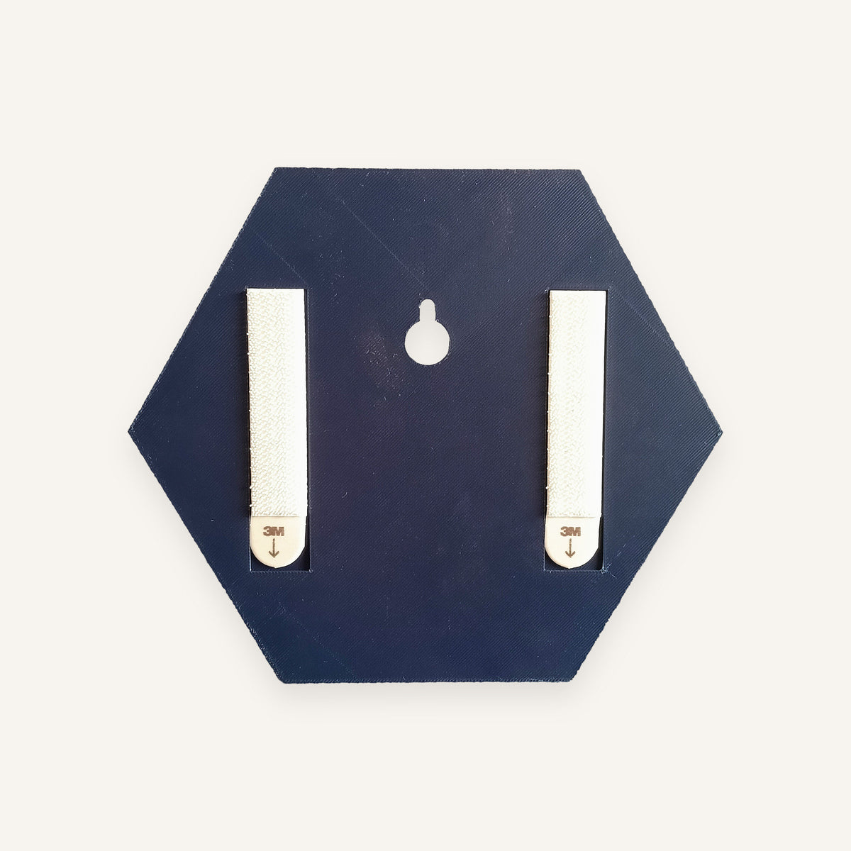 Back of a Navy backpiece with two adhesive hanging strips and a keyhole