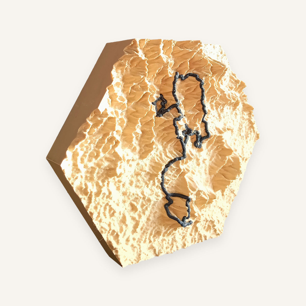 Sand-coloured 3D terrain piece with a raised navy route line, seen at an angle to show the relief